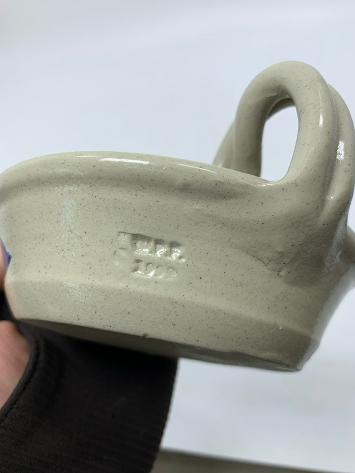 GRAY POTTERY TAPERED CANDLE HOLDER W/ BLUE FLOWER/HANDLE.