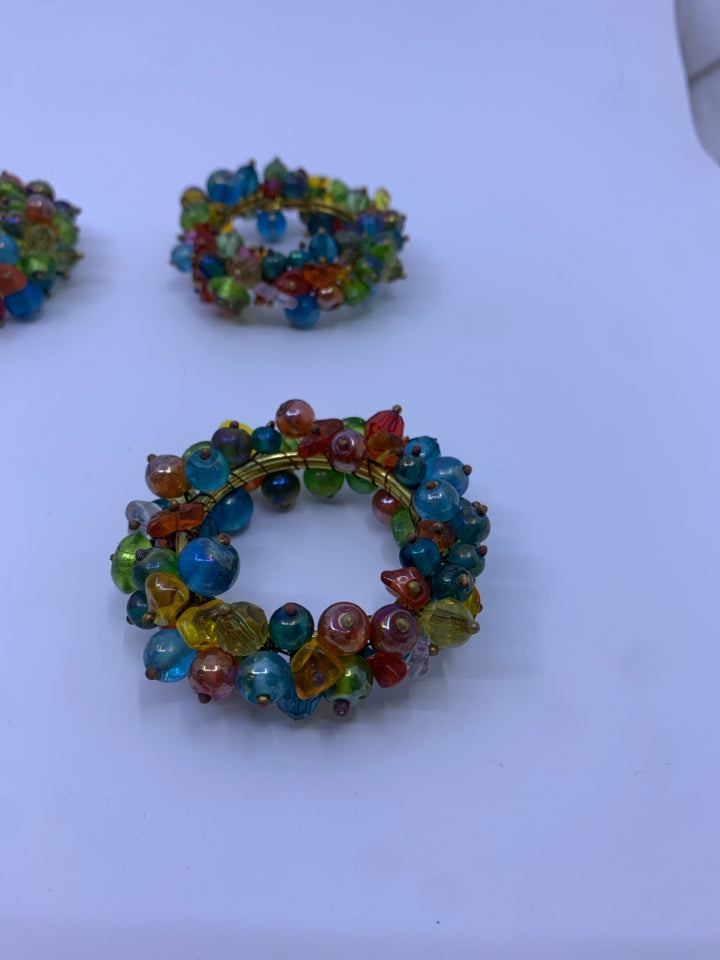 10 MULTI COLORED BEADS NAPKIN RINGS.