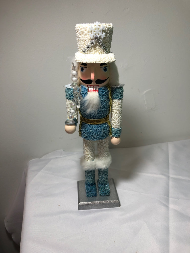 LIGHT BLUE AND WHITE SNOWFLAKE NUT CRACKER.