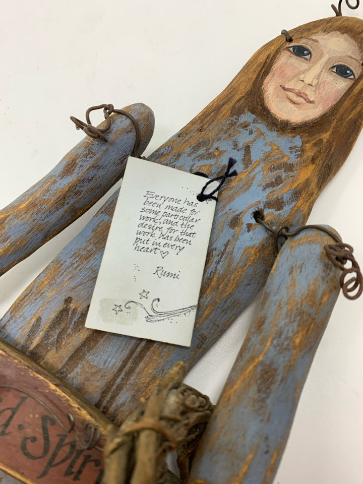 PRIMITIVE WOOD DOLL W WATERING CAN WALL HANGING.
