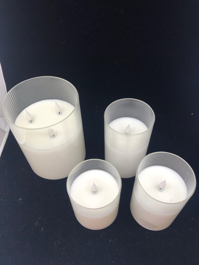 4 LIGHT UP PILLAR GLASS CANDLES.