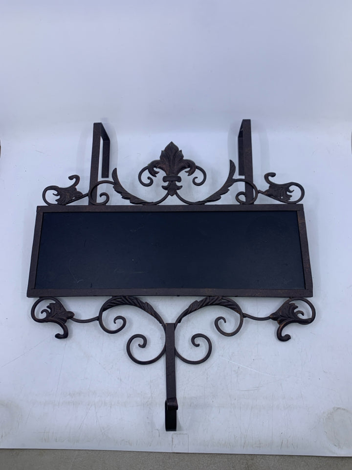 BROWN METAL SCROLL OVER THE DOOR HOOK W/ CHALK BOARD FRONT.