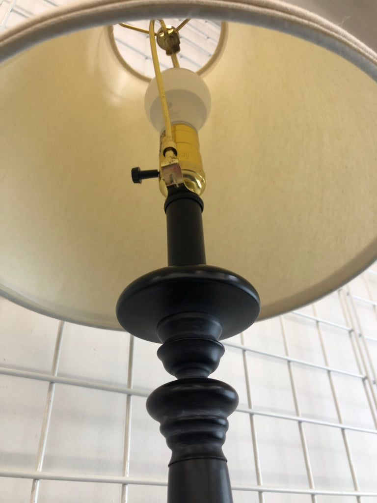 TALL BLACK LAMP W/CREAM FABRIC SHADE.