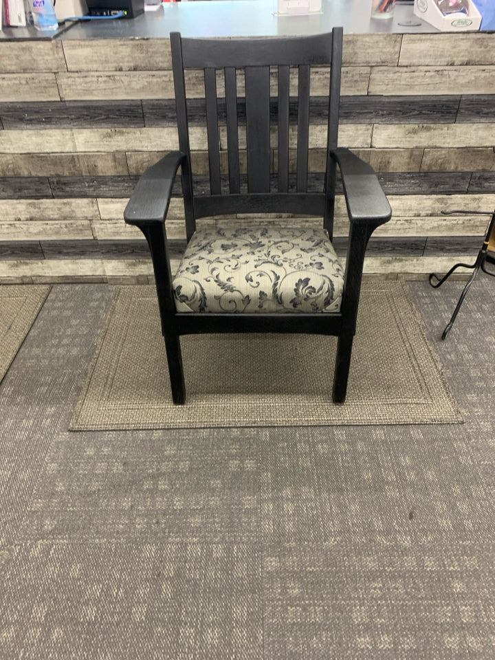 BLACK WOOD CHAIR W/ GREY BLACK LEAF DESIGN CUSHION.