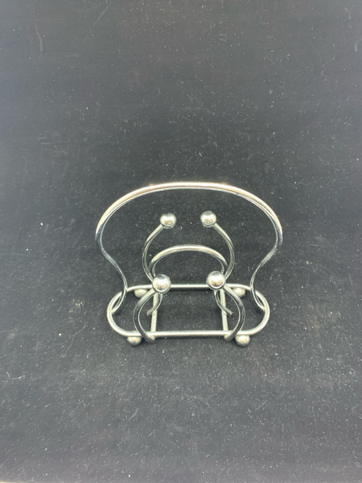 SILVER METAL NAPKIN HOLDER.