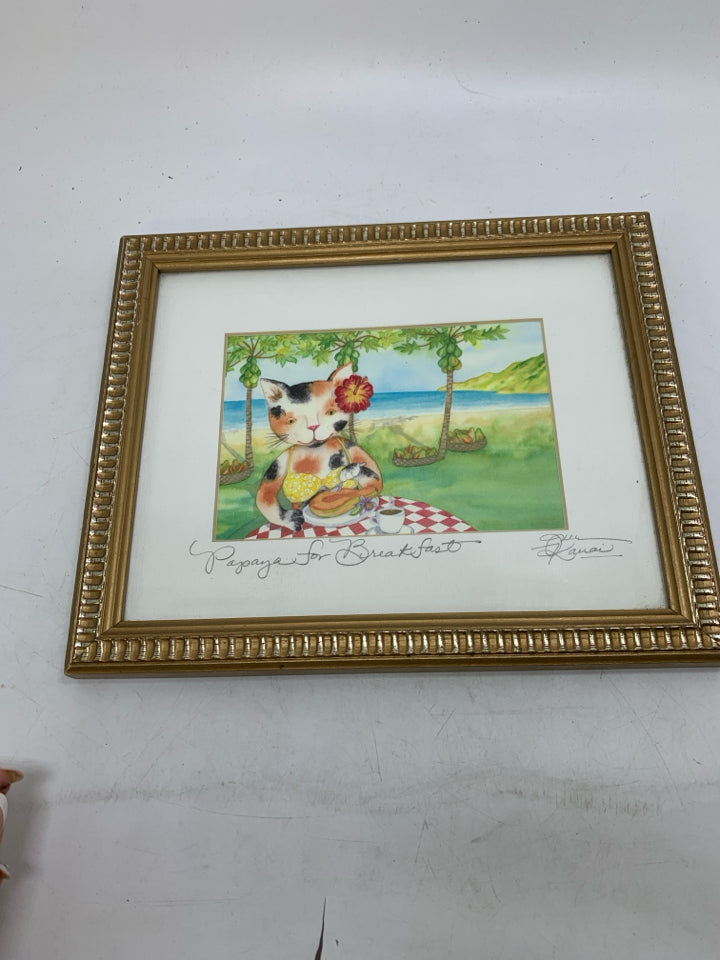 CAT W/ BATHING SUIT EATING PAPAYA WALL HANGING.