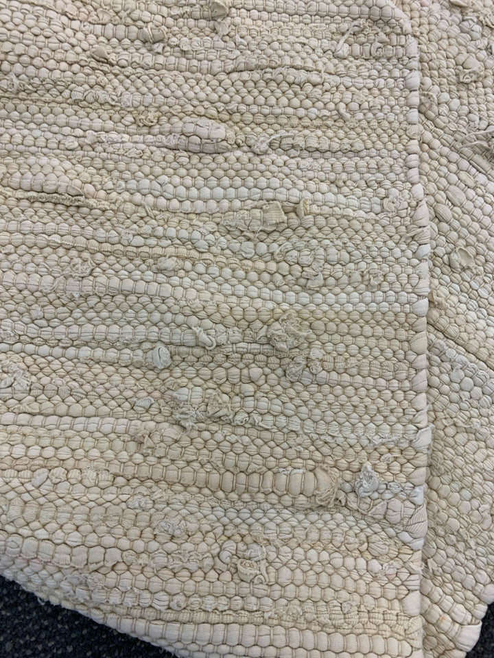 WOVEN FABRIC BEIGE RUG.