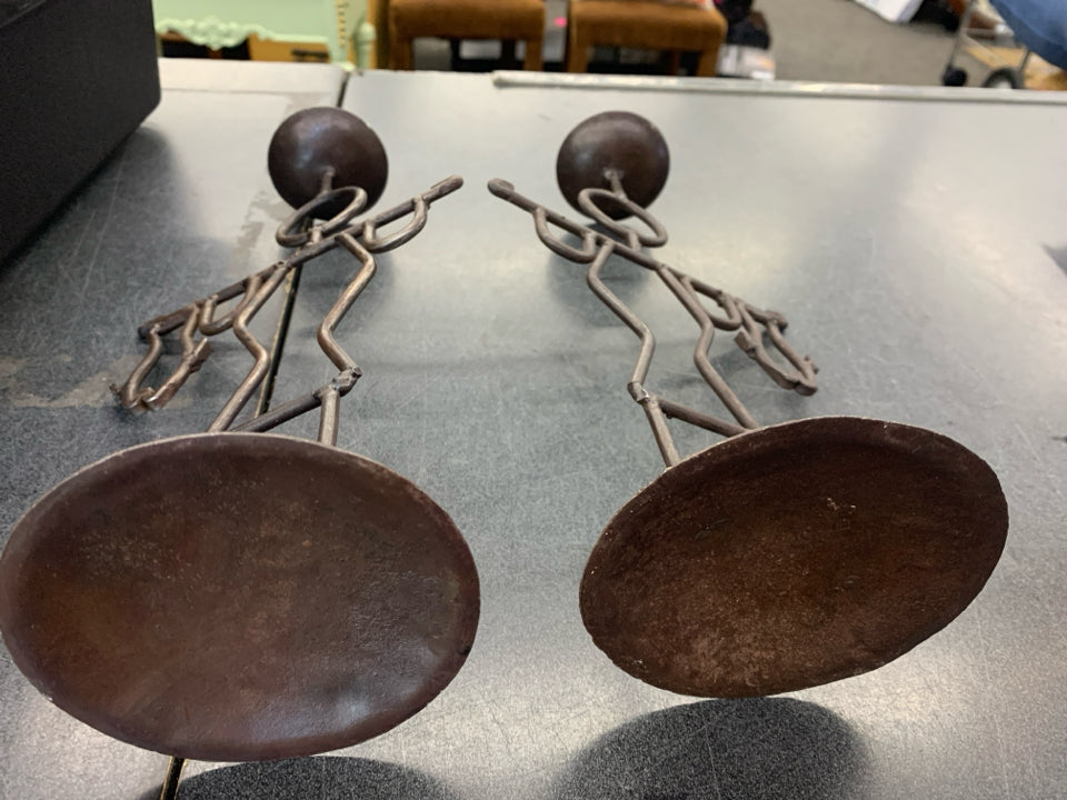 2 BROWN IRON MEN HOLDING FISH CANDLE STICK HOLDERS.