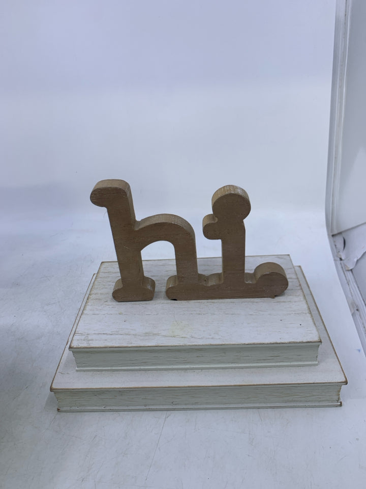 WHITE 2 STACKED BOOKS W/ HI ON TOP.