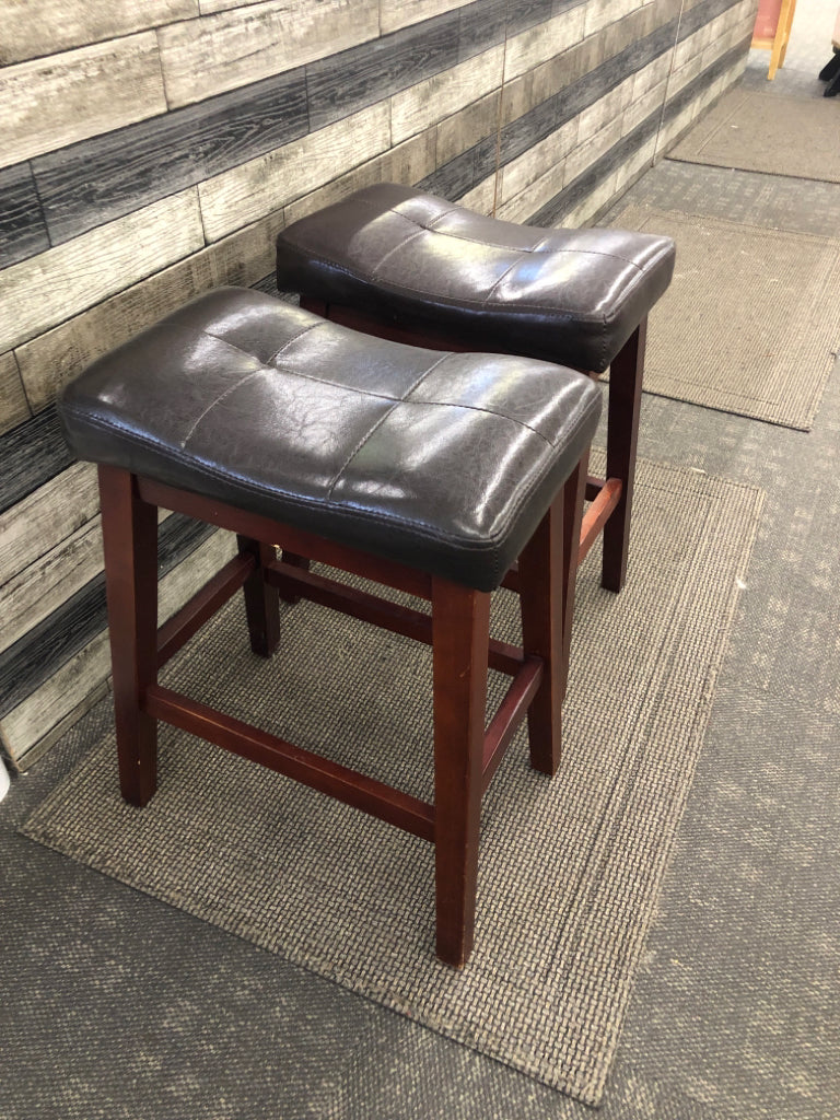 2 BROWN FAUX LEATHER STOOLS W/WOOD LEGS.