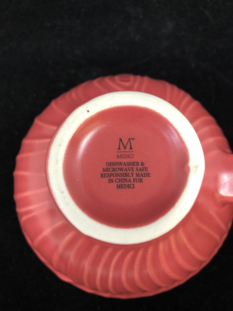 RED MUG W/FLORAL DETAILS INSIDE.