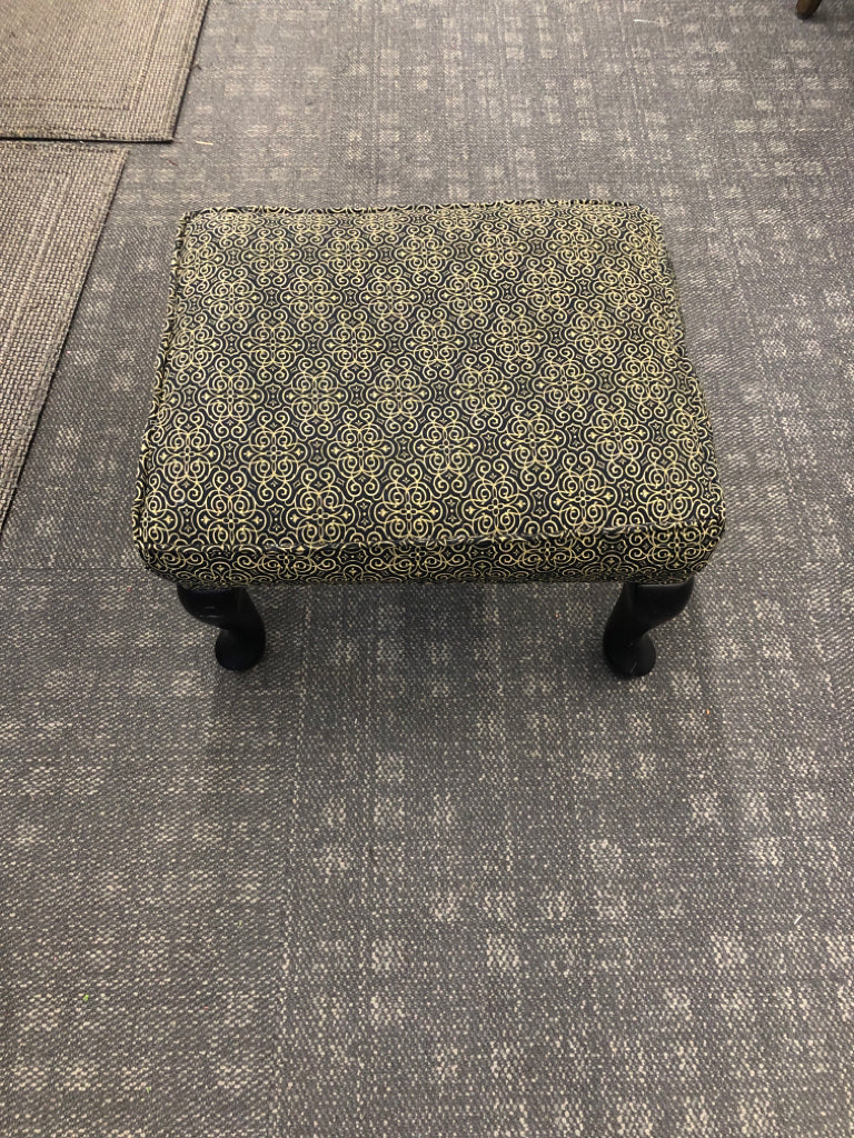BLACK AND GOLD SCROLL PATTERN OTTOMAN.