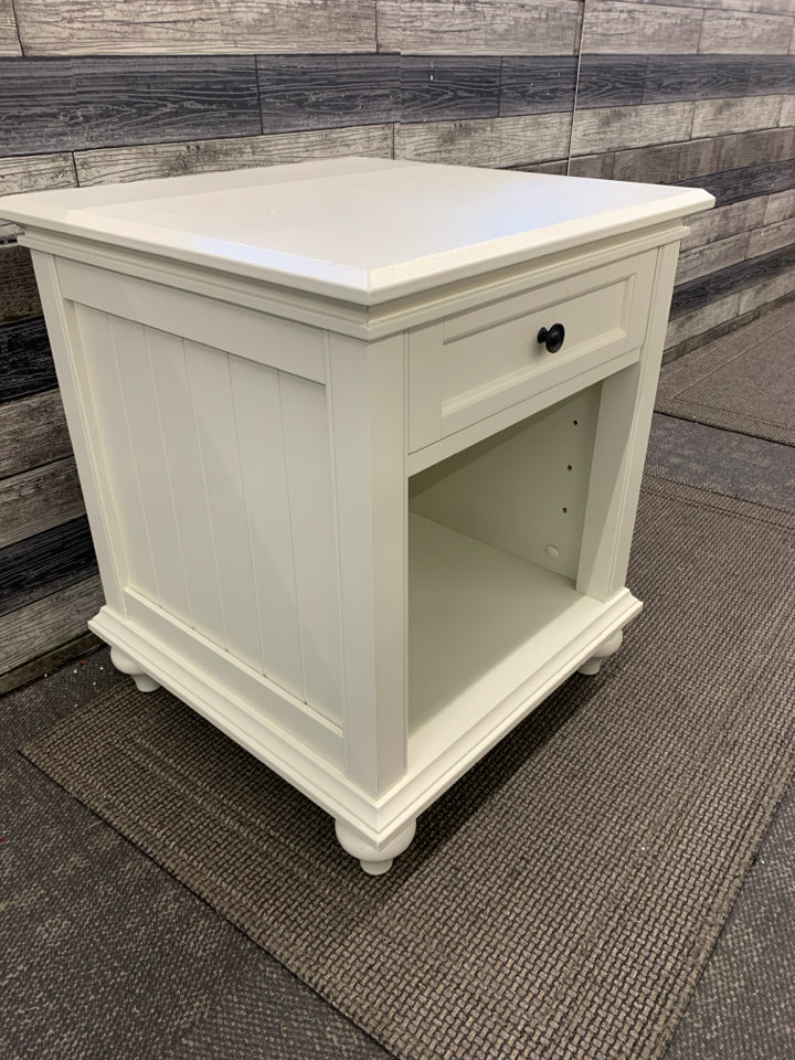 WHITE NIGHT STAND W/ DRAWER BLACK HARDWARE.