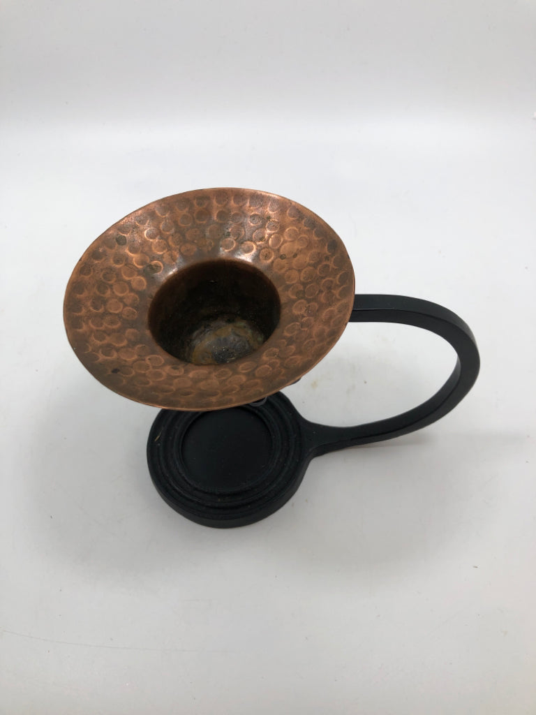 COPPER TEA LIGHT HOLDER IN BLACK METAL STAND.
