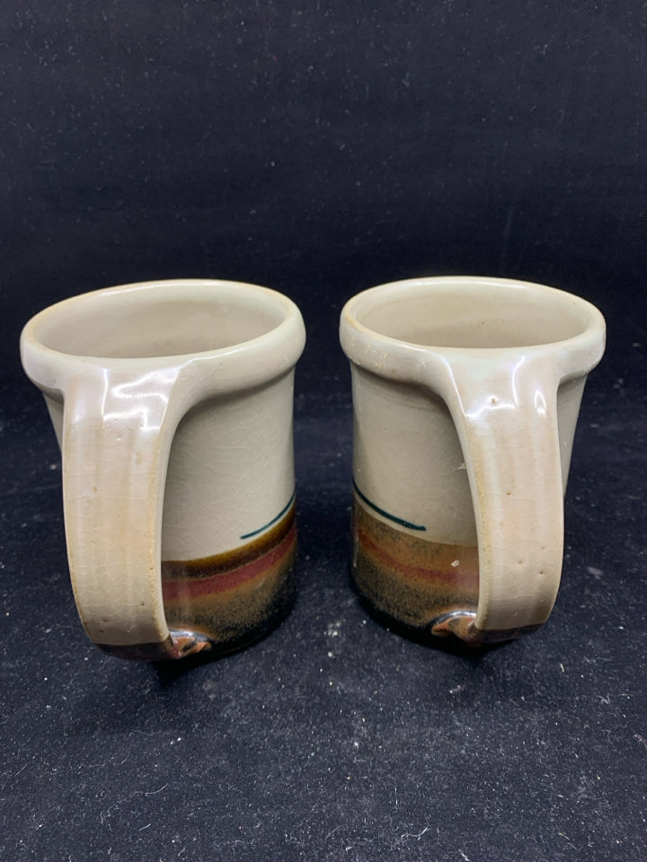 2 POTTERY MUGS W/ GRAY,DARK BROWN, RED BOTTOM W/ LEAF.