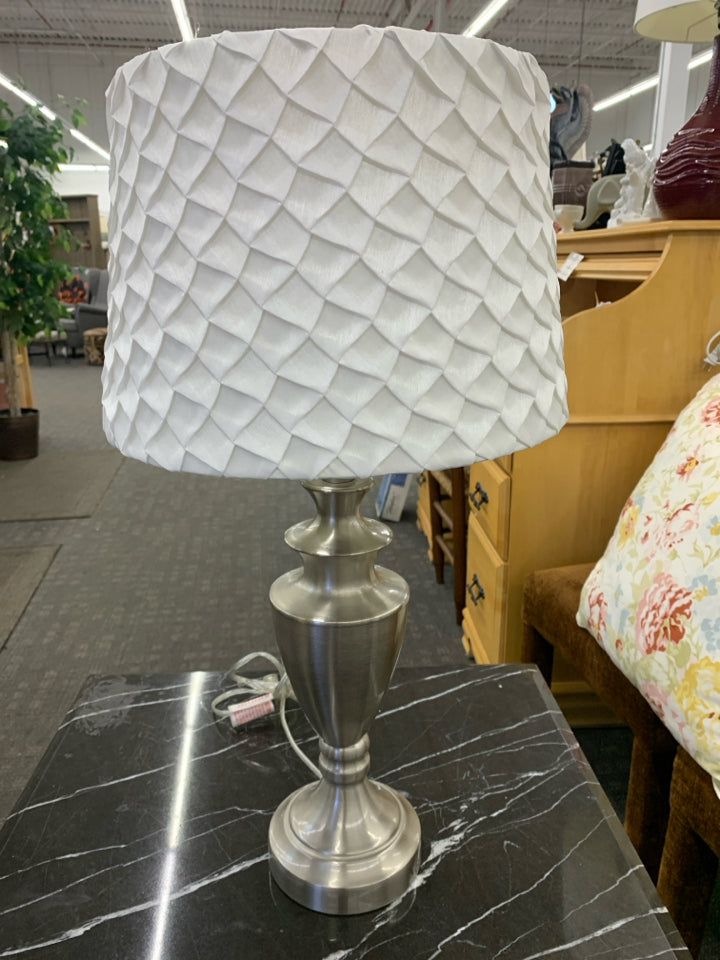 SILVER BASE LAMP W WHITE RUFFLED SHADE.