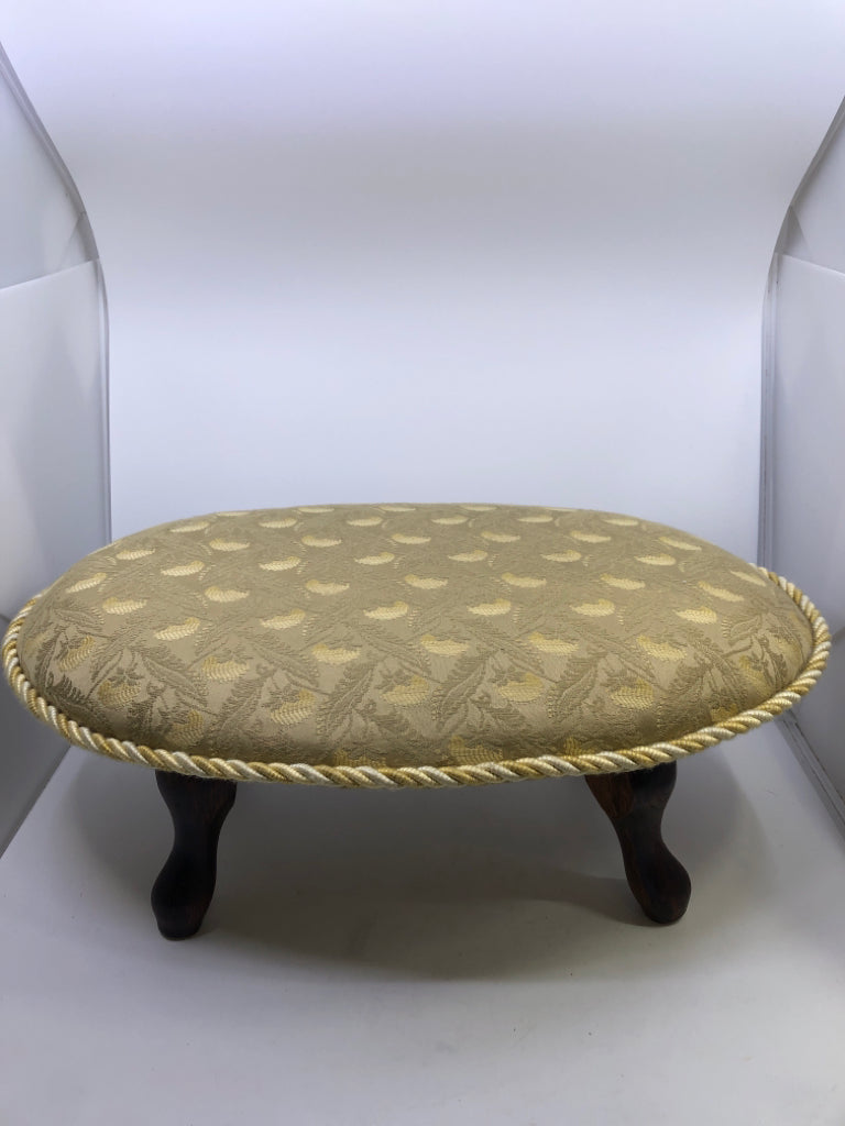 YELLOW FOOT REST FLORAL PATTERN W/TWISTED CHORD EDGE & DARK WOOD FEET.