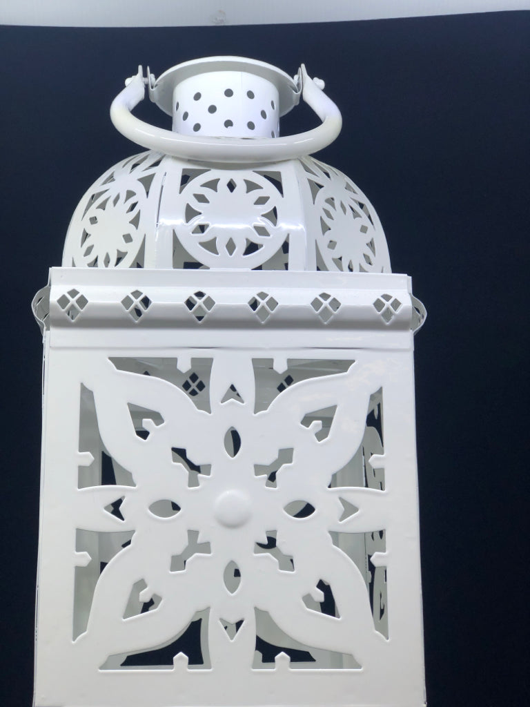 FOOTED WHITE PIERCED METAL LANTERN.
