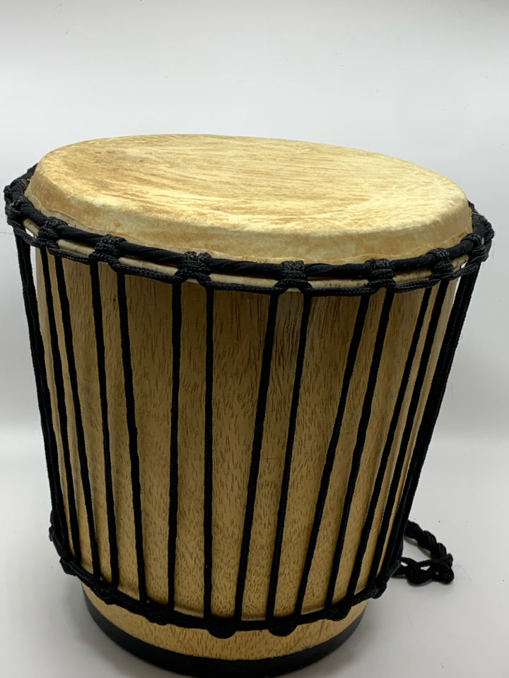 LIGHT COLORED DRUM W/BLACK ROPE.