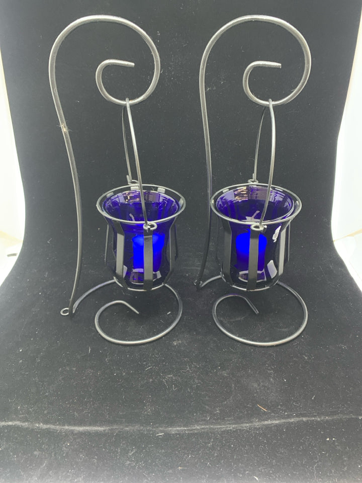 2 HANGING BLUE GLASS CANDLE HOLDERS.