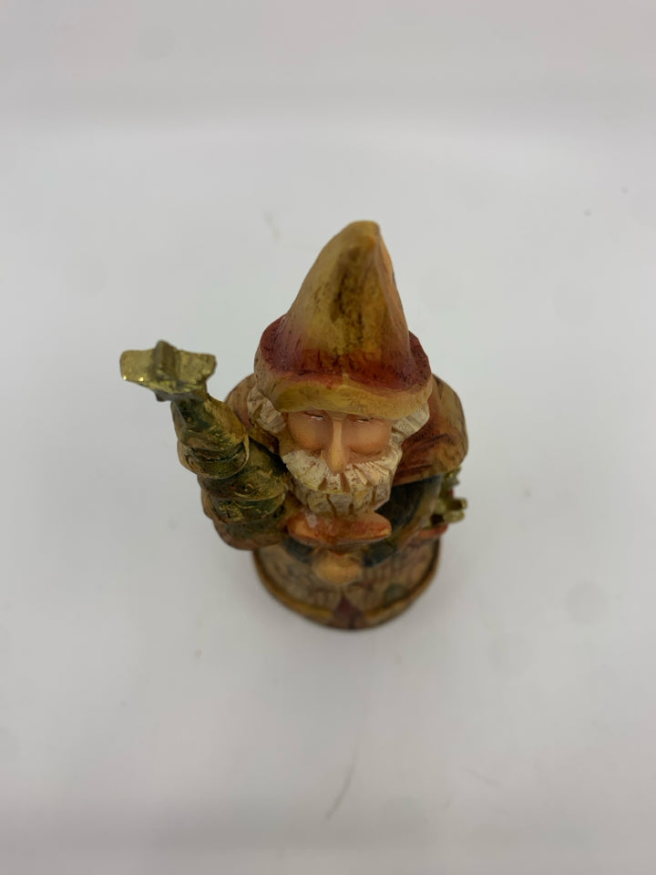 RESIN SANTA HOLDING CHRISTMAS TREE.