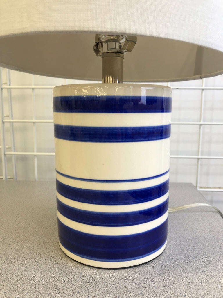 BLUE WHITE STRIPE CERAMIC LAMP W/WHITE SHADE.
