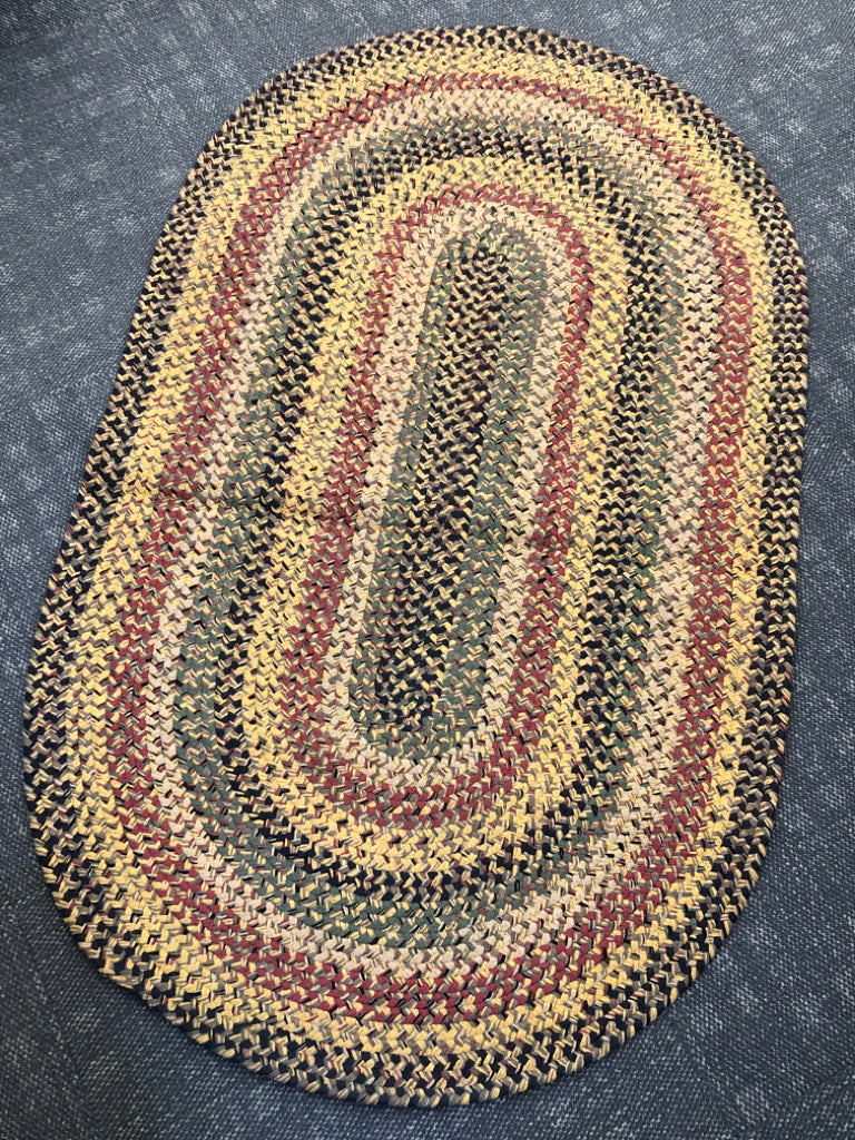 OVAL BRAIDED RUG.