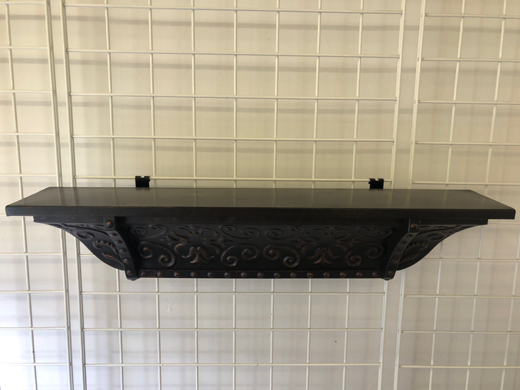 BLACK METAL SCROLL WALL SHELF W/ EMBOSSED DETAIL.