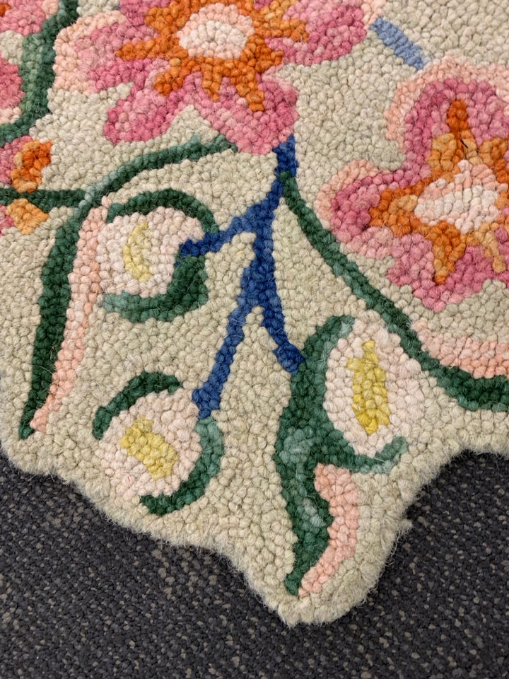 GOODWEAVE TAN RUG W/ COLORFUL FLOWERS.