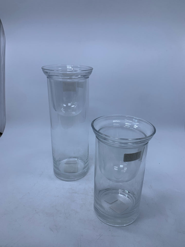 2 CLEAR GLASS CYLINDERS W/ DROP IN TEA LIGHTS.