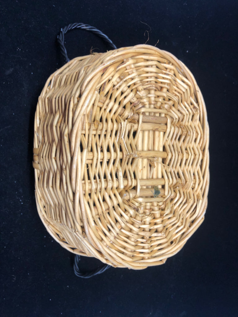 BLONDE OVAL BASKET W BLACK METAL HANDLES/RIM.