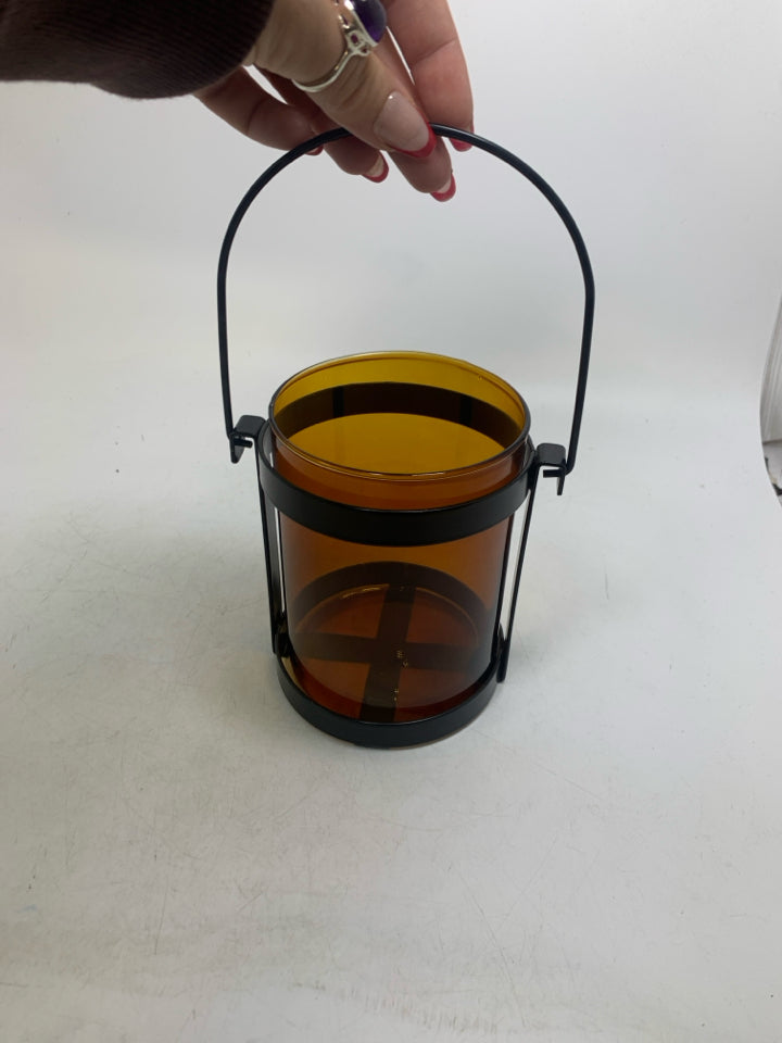 BROWN GLASS INSERT W/ BLACK METAL STAND LANTERN.