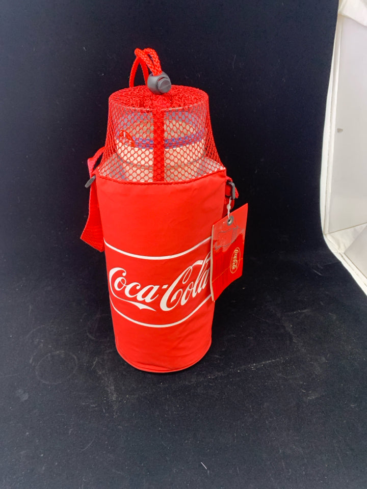 4 COCA-COLA THEMED STACKABLE GLASSES IN CARRYING SLEEVE.