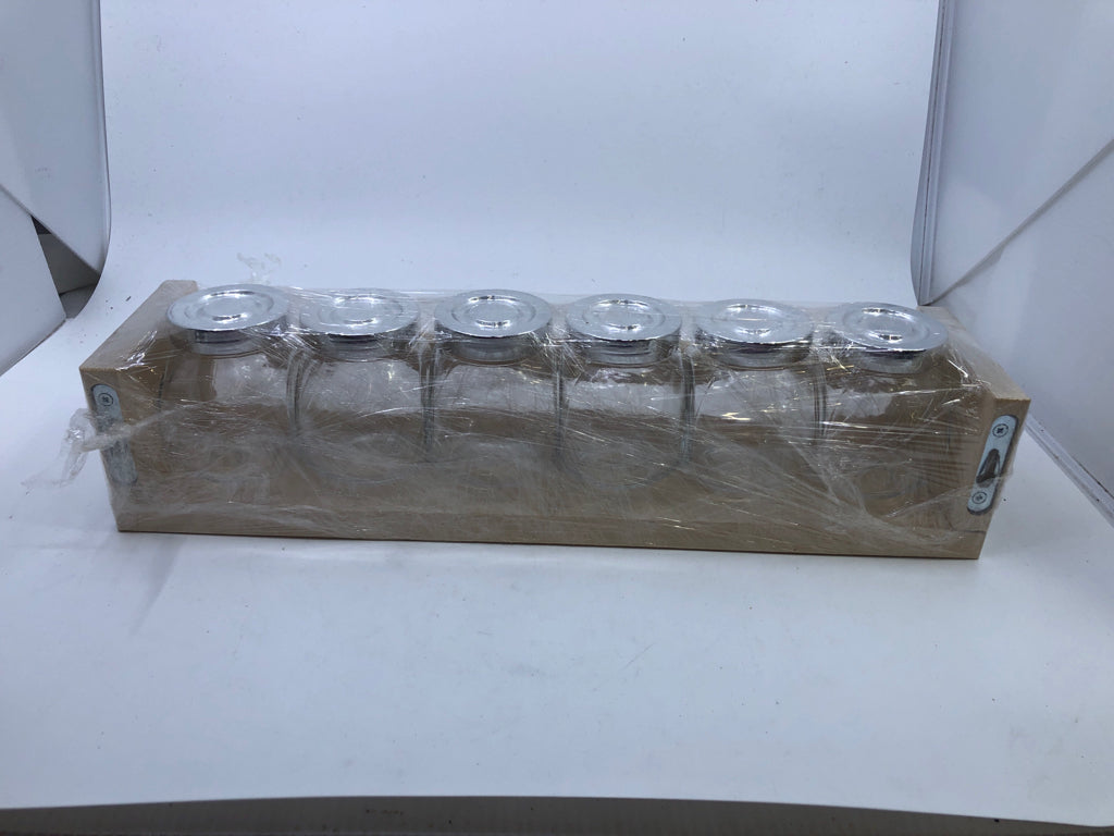 GLASS JARS IN WHITE SHELF.