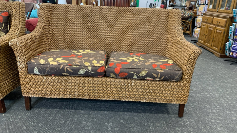 WICKER SOFA W/BROWN CUSHION.