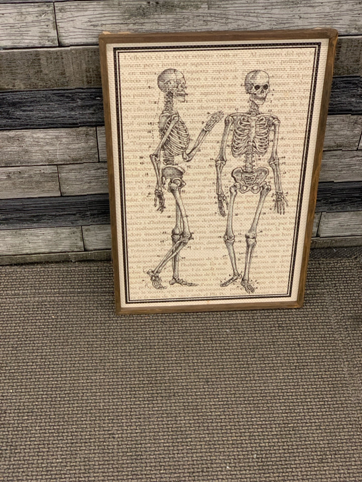 SKELETONS WOVEN PRINT IN WOOD FRAME.