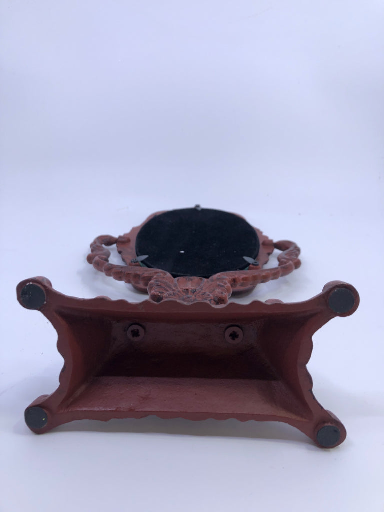 HEAVY RED METAL ORNATE MIRROR.