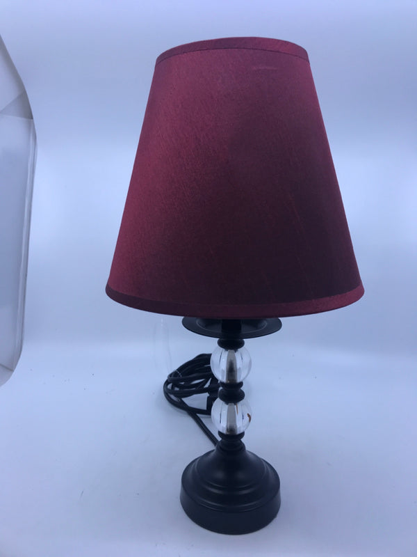 SMALL BLACK/CLEAR BASE LAMP W/ RED SHADE.