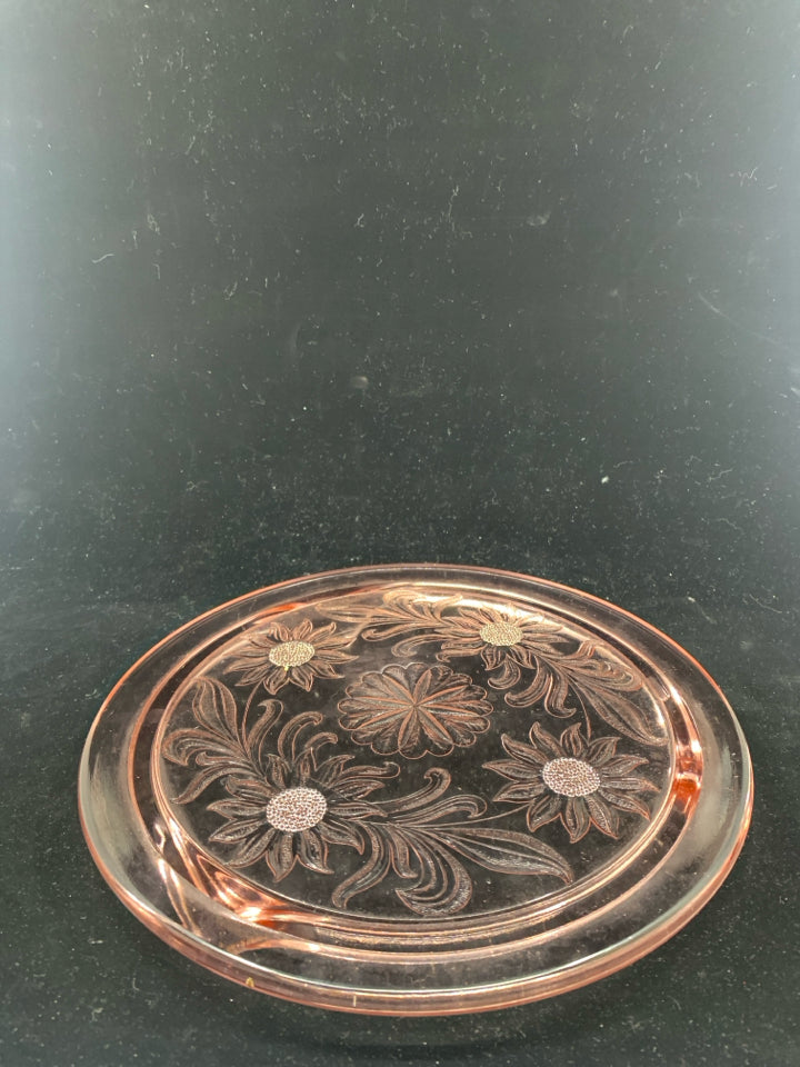 FOOTED PINK GLASS CIRCLE PLATTER W/ EMBOSSED FLOWERS.