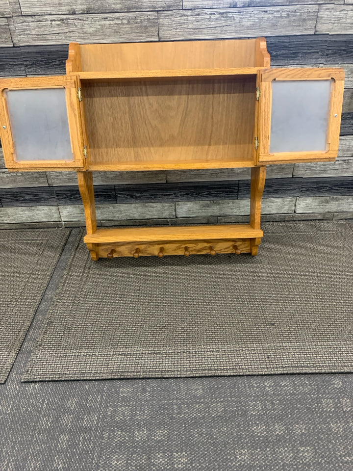 OAK WOOD SHELF W CABINET AND 6 HOOKS.