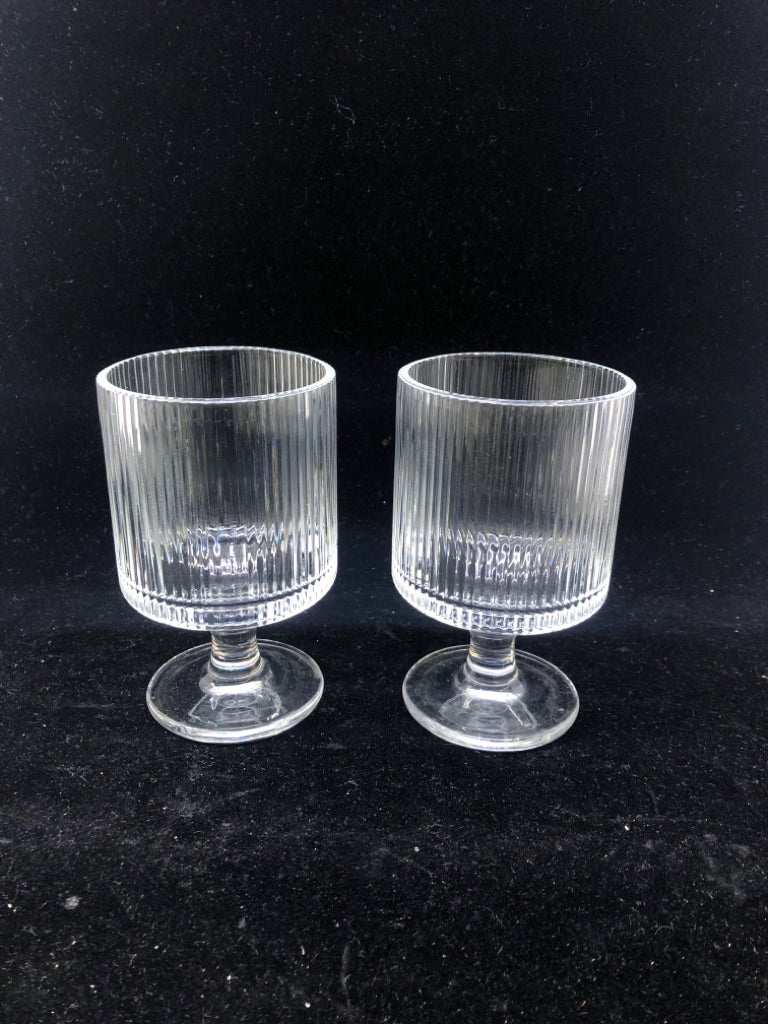 2 RIBBED GLASS FOOTED GLASSES.