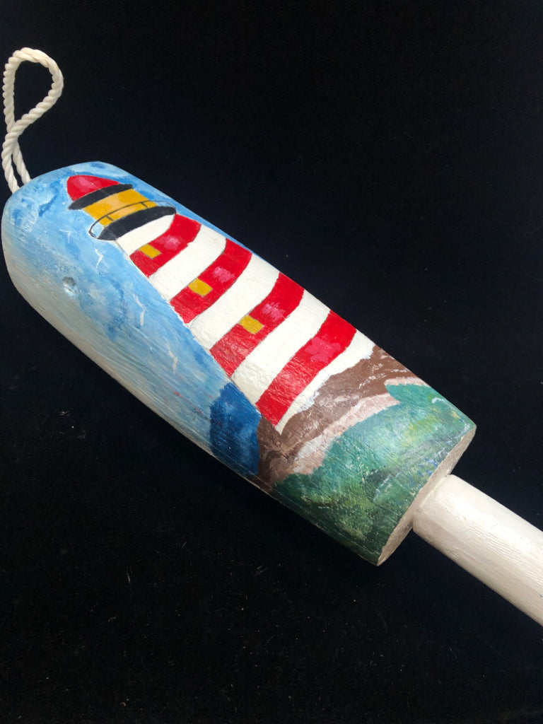 WHITE WOODEN BUOY W/PAINTED LIGHTHOUSE.
