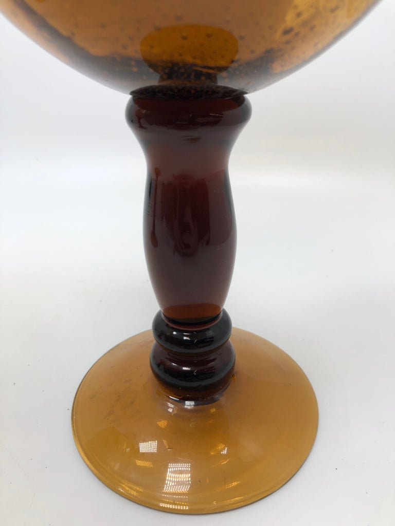 2 AMBER GLASS CANDLE HOLDERS W/WAX CANDLES.