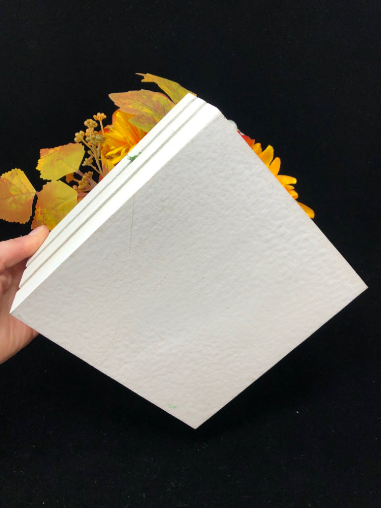 WHITE SLOTED PLANTER W/ FALL FLORAL ARRANGEMENT.