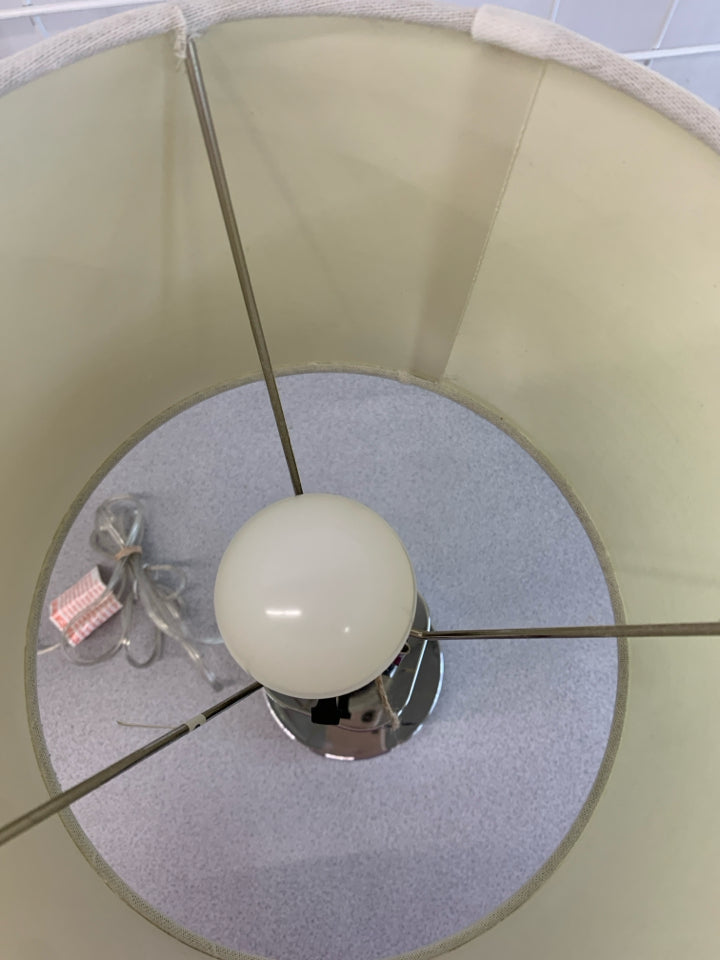 CLEAR/SILVER BASE LAMP W/WHITE SHADE.