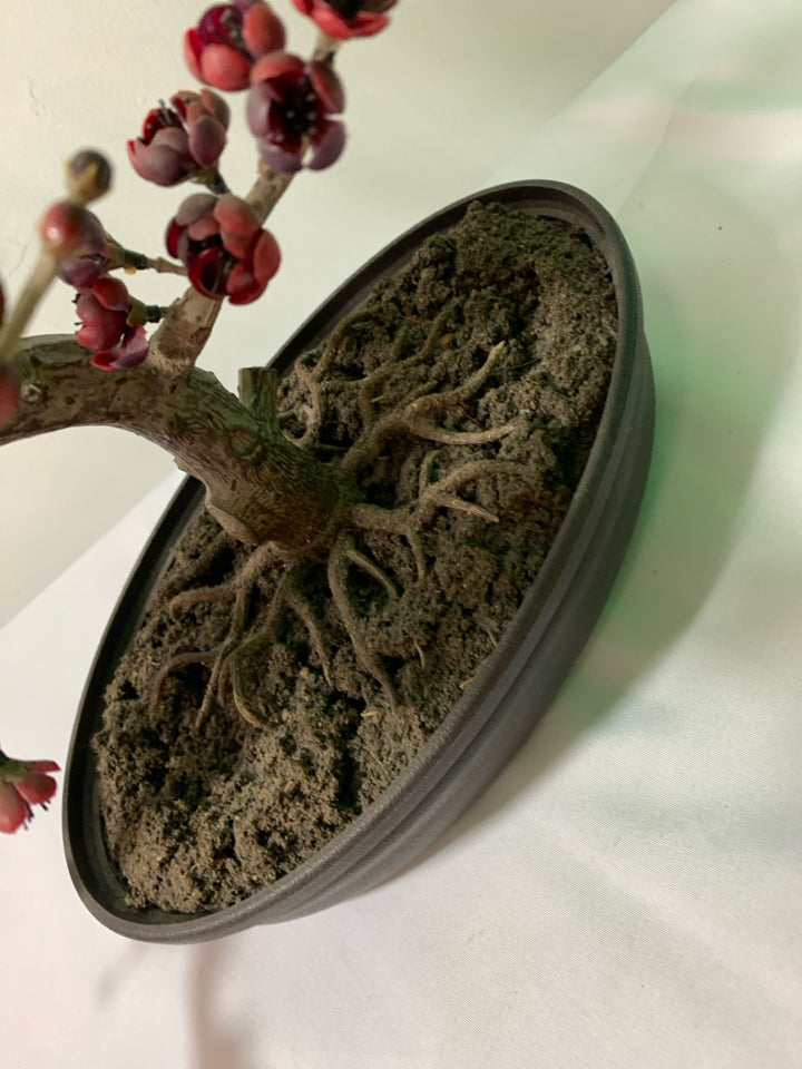 FAUX BONSAI TREE W/ RED FLOWERS IN OVAL PLANTER.