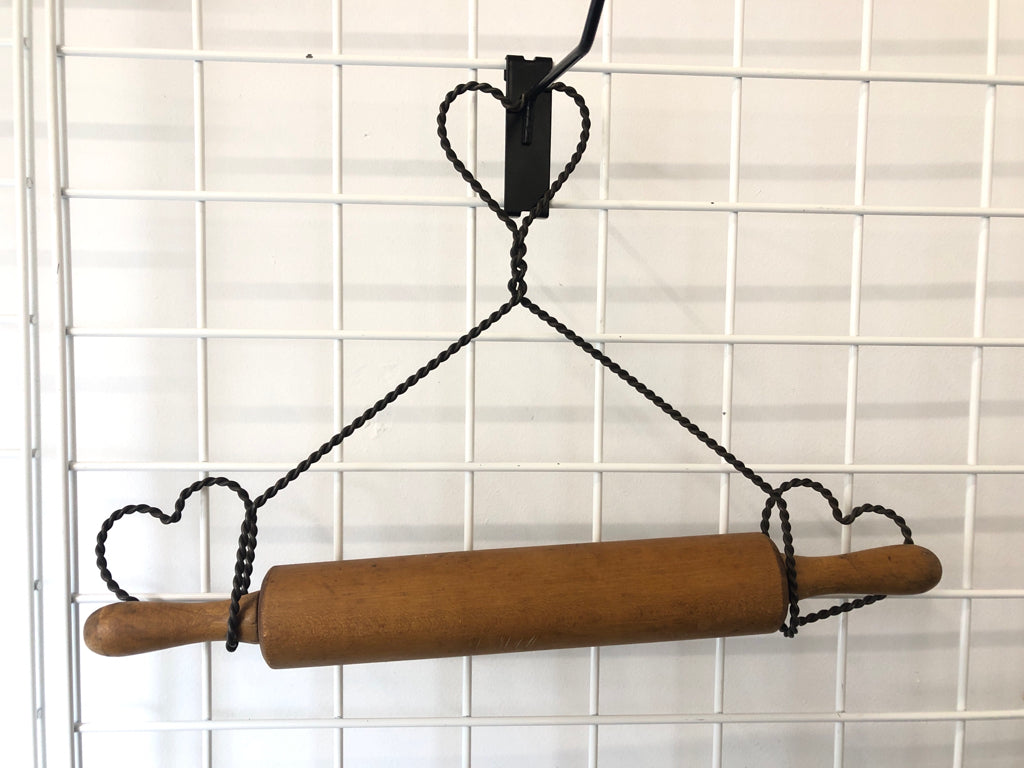 PRIMITIVE ROLLING PIN IN METAL WIRE HOLDER.