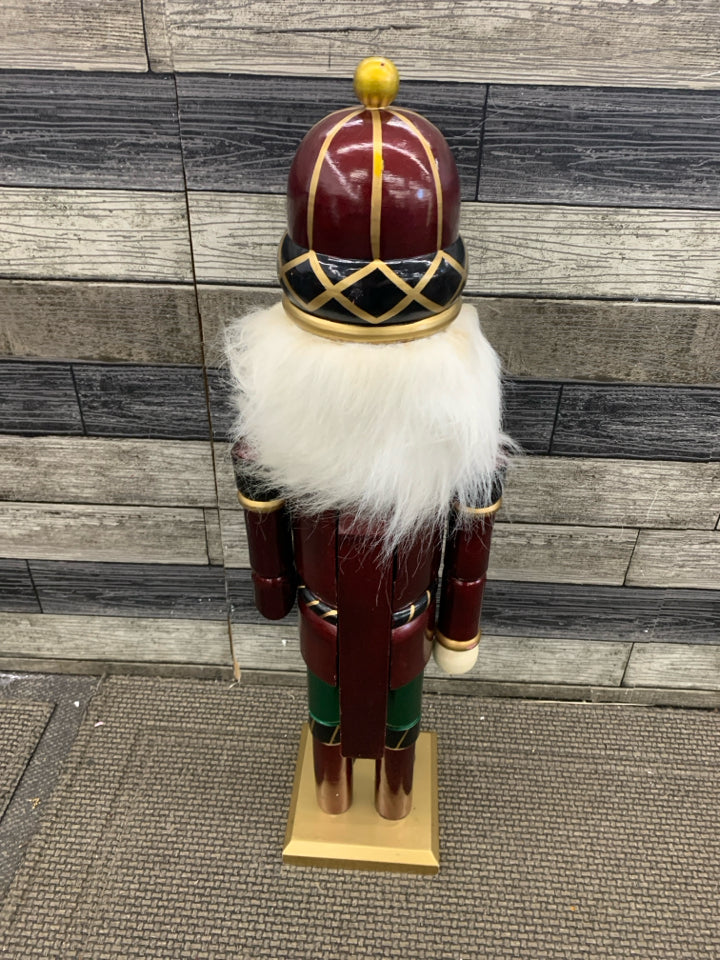 TALL NUTCRACKER HOLDING NUTCRACKER.