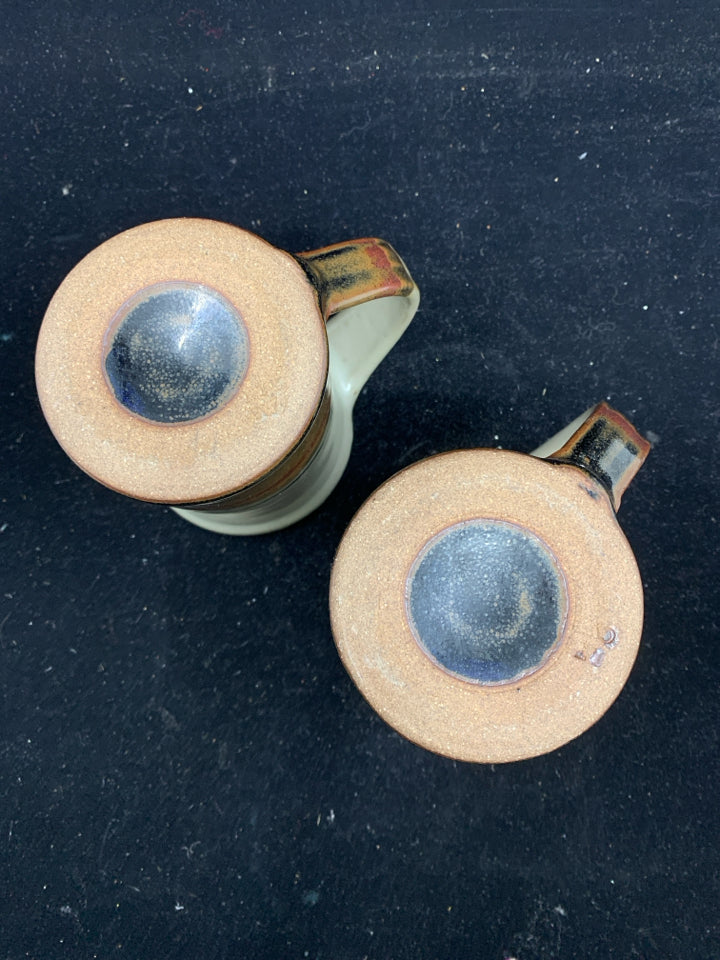 2 POTTERY MUGS W/ GRAY,DARK BROWN, RED BOTTOM W/ LEAF.