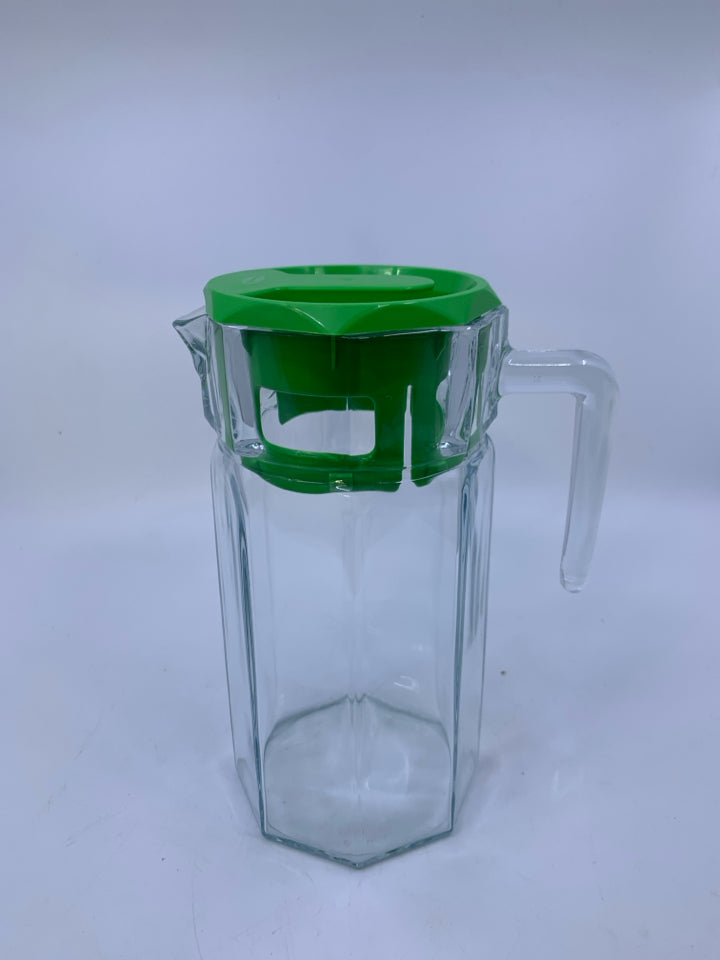 CLEAR GLASS PITCHER W/ GREEN PLASTIC TOP.
